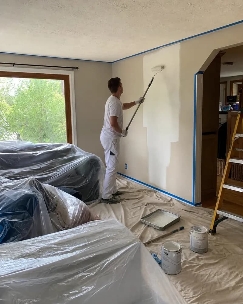 Interior painting work in progress with room surfaces prepared for coating